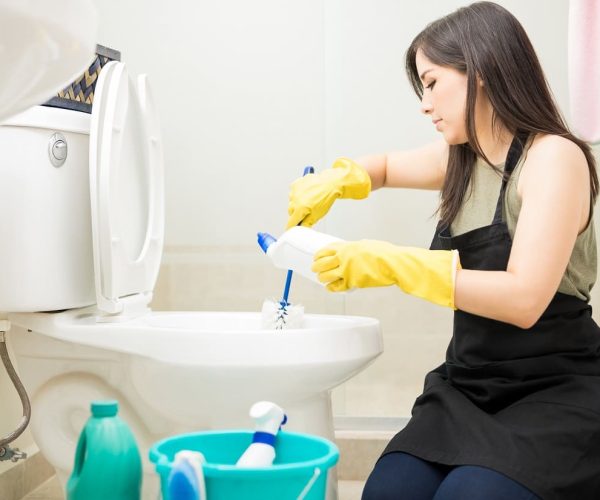 young-maid-in-yellow-glove-cleaning-toilet-bowl-us-2025-06-22-06-18-07-utc